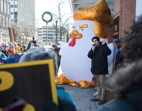 Protesters rally outside Rep. Katko’s office, bringing along a giant chicken resembling President Donald Trump