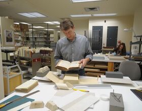 Artifacts in the libraries are deteriorating. SU delayed a plan to save them.