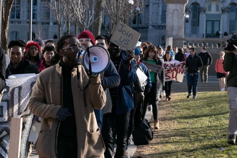 Faculty and students march across campus in support of #NotAgainSU